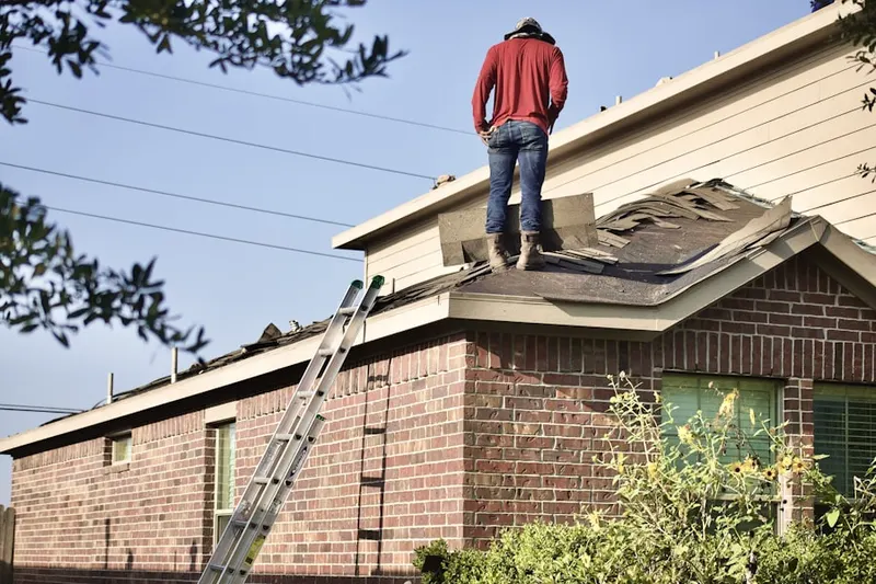 Professional roofer working on a residential roof in Oak Hollow